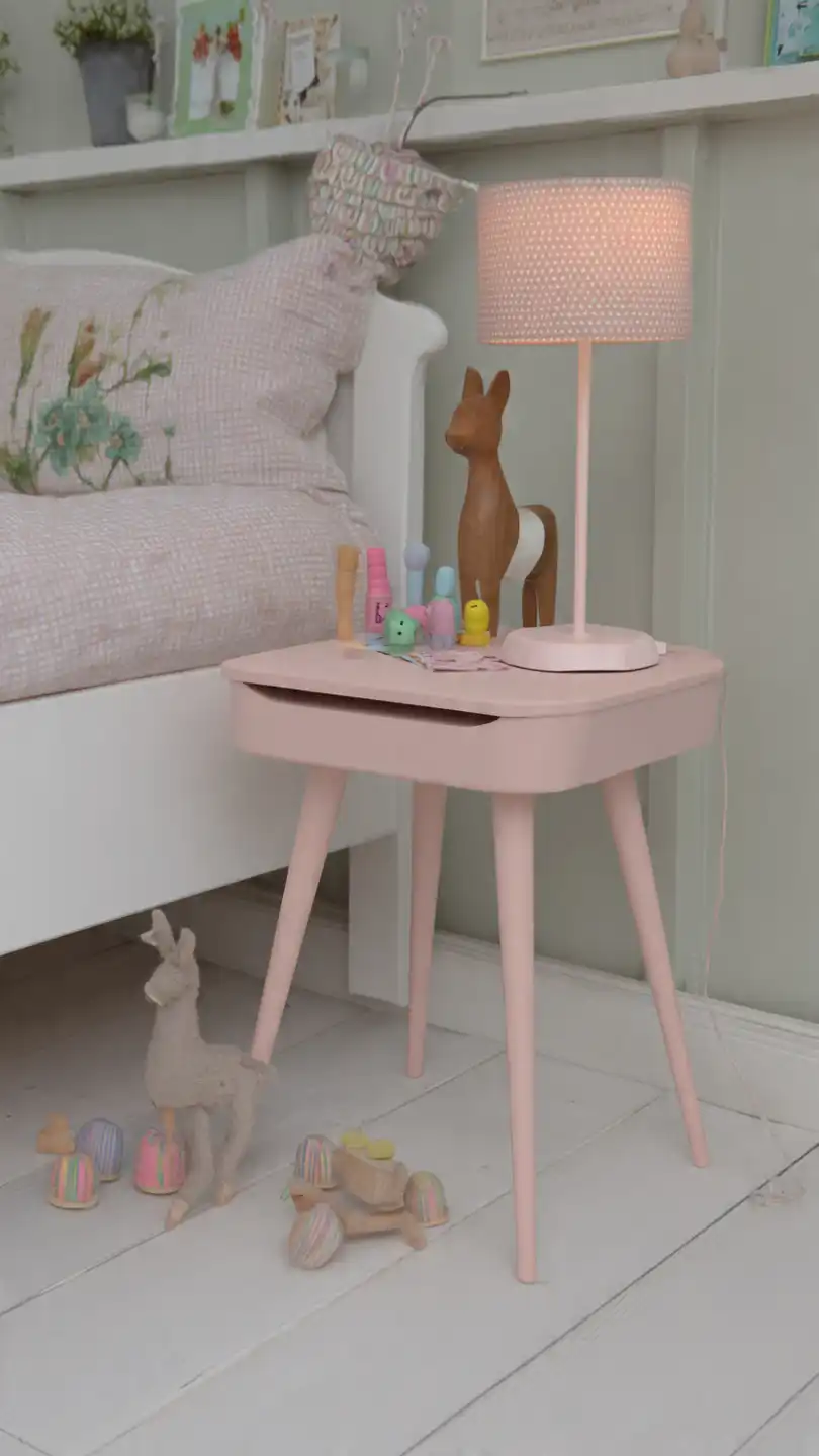 a cute small wooden bedside table painted